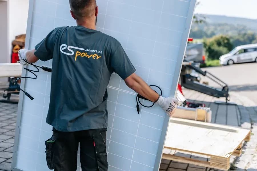 Monteur von es power mit Solarmodul, von hinten